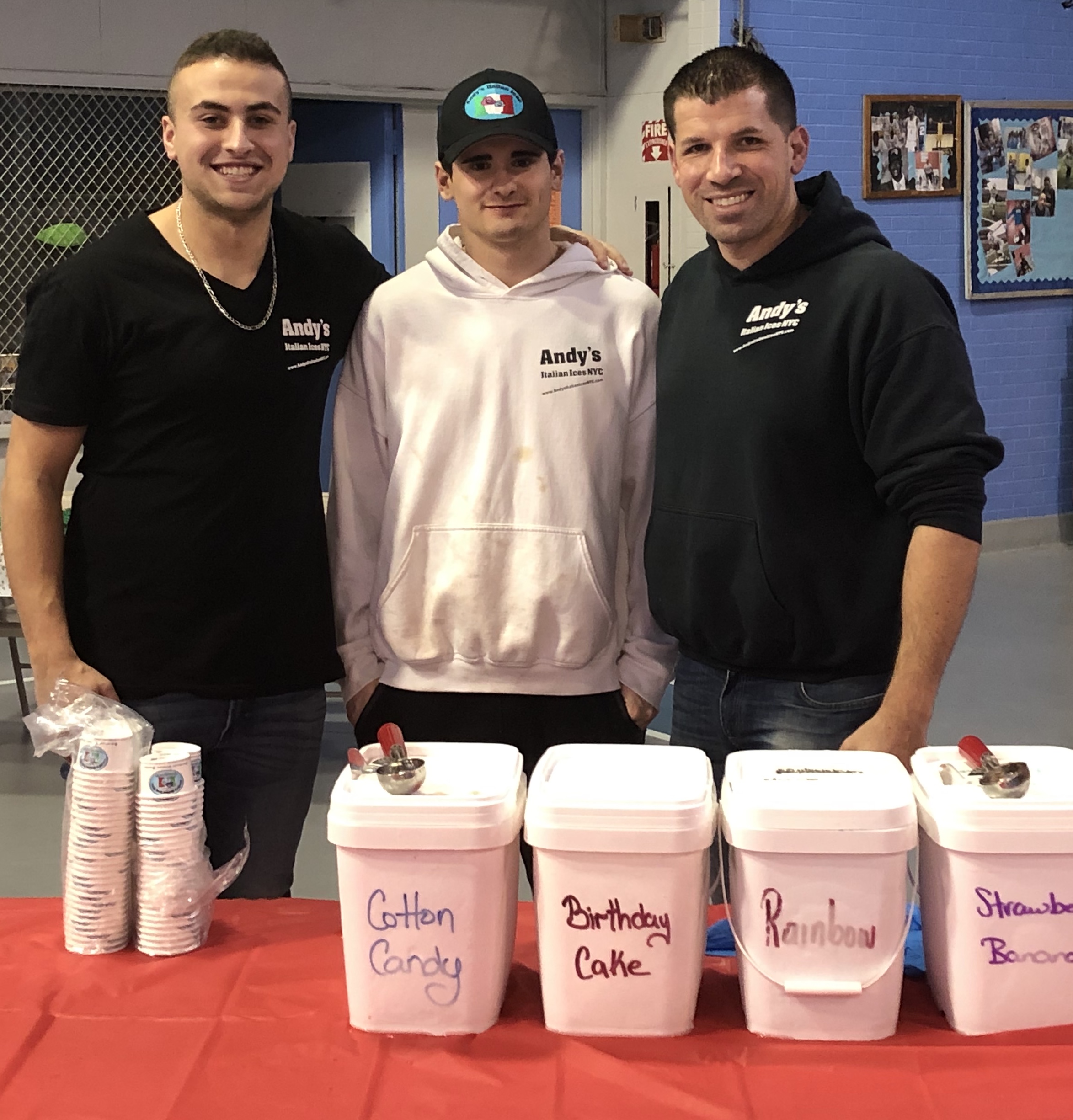 Employees standing with buckets of ice cream